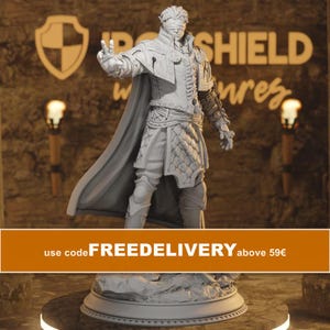 May include: A light gray, unpainted resin miniature figure of a blindfolded character in fantasy attire, featuring a long cape, textured armor, and an outstretched hand with two fingers raised, standing on a rocky base with a circular platform.