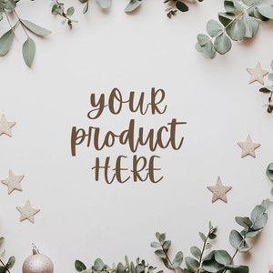 May include: A white background with a border of green eucalyptus leaves and gold glitter stars. The text "your product here" is written in the center of the image.