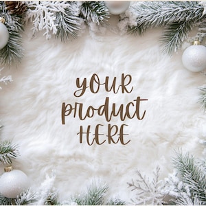 May include: A white faux fur background with a snowy evergreen garland border. The garland is decorated with silver baubles and the text "your product here" is written in the centre.