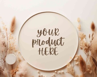 May include: A white round frame with a beige background and the text "your product here" written in brown cursive. The frame is surrounded by dried flowers and grasses in shades of beige and brown.