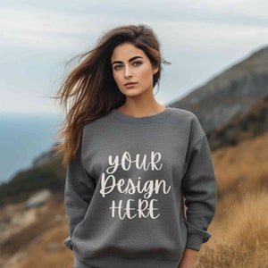 May include: A grey sweatshirt with the text "your design here" in white lettering.