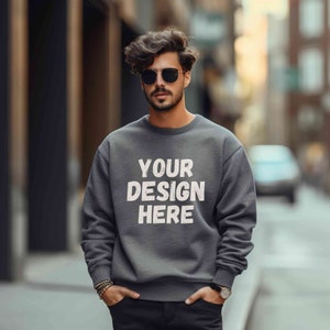 May include: A dark gray sweatshirt with the text "YOUR DESIGN HERE" printed in white on the front.