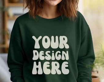 May include: A dark green sweatshirt with the text "YOUR DESIGN HERE" in white, stylized lettering.