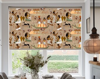 May include: A beige window blind with a repeating pattern of Egyptian hieroglyphics and figures. The figures are depicted in a traditional style, with vibrant colors and intricate details. The blind is partially rolled up, revealing a view of a dining room with a wooden table and chairs.