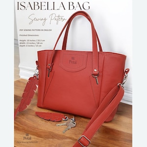 May include: A red leather tote bag with a detachable shoulder strap and a zipper closure. The bag has a logo that says "Petal" and the text "Isabella Bag Sewing Pattern" is at the top of the image.