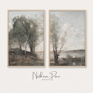 May include: A set of two framed landscape paintings. The paintings are in a muted color palette of blues and grays. The left painting features a group of trees in a forest setting. The right painting features a single tree by a body of water with a person sitting in a boat.
