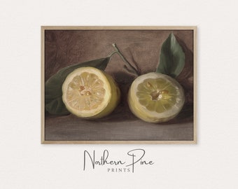 May include: A framed print featuring a still life of two halved lemons with green leaves. The lemons are yellow with a textured surface, set against a brown and gray background. The print is from Northern Pine Prints.