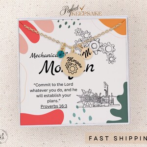 May include: A gold necklace with a charm that says "Morgan" and a small gear charm. The necklace is in a white box with a quote from Proverbs 16:3, "Commit to the Lord whatever you do, and he will establish your plans."