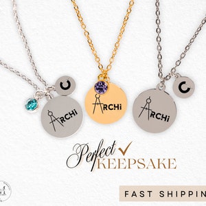 May include: Three silver necklaces with a compass and the word "ARCHI" engraved on a round pendant. Each necklace has a small charm with a letter and a crystal. The necklaces are on a white background with the text "Perfect Keepsake" and "FAST SHIPPING".