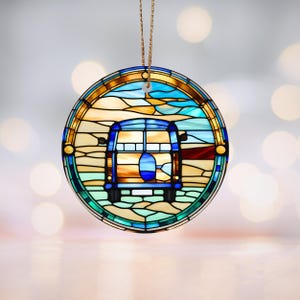 Könnte beinhalten: Ein runder, aus farbigem Glas gefertigter Anhänger mit einem blauen und gelben Vintage-Van, der an einem Strand entlangfährt. Der Van hat eine blaue Karosserie und gelbe Fenster. Der Hintergrund ist eine Strandkulisse mit blauem Wasser und gelbem Sand.