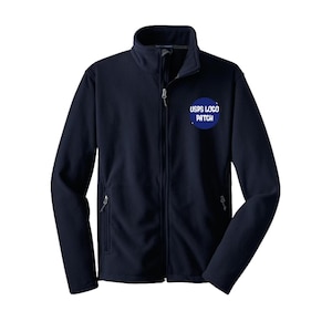 May include: A navy blue fleece jacket with a full zip and two side pockets. A blue circular patch on the chest reads "USPS LOGO PATCH". The jacket features a high collar and is designed for warmth and comfort.