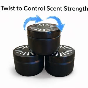 May include: Three black scent containers with white accents on the lids are stacked. The text "Twist to Control Scent Strength" is above the containers, with blue arrows indicating how to use the product.