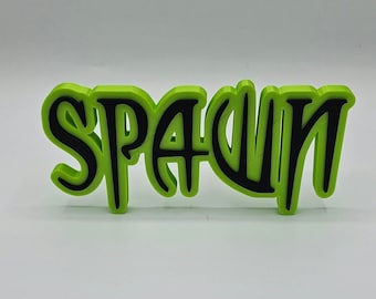 Könnte beinhalten: Ein grünes, 3D-gedrucktes Wortschild mit der Aufschrift "Spawn" in schwarzen Buchstaben.