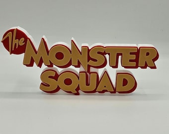 May include: The Monster Squad logo in red and gold letters. The word "The" is in red and the rest of the logo is in gold.