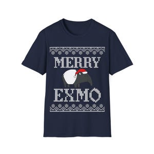 May include: Navy blue t-shirt with a festive design. The shirt features the text "MERRY EXMO" in white, with a tapir wearing a Santa hat. The design includes snowflake patterns at the top and bottom.
