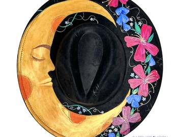 May include: A black felt hat with a crescent moon design painted on the brim. The moon is gold with a face and is surrounded by pink, purple, and blue flowers.