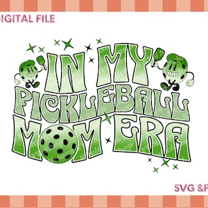 May include: Green and white graphic design with the text "In My Pickleball Mom Era" with a pickleball and paddle design.