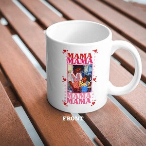 May include: White ceramic mug with a black and white photo of a mother and child. The mug has the text "Mama Mama Mama Mama" in pink letters with hearts around the text.