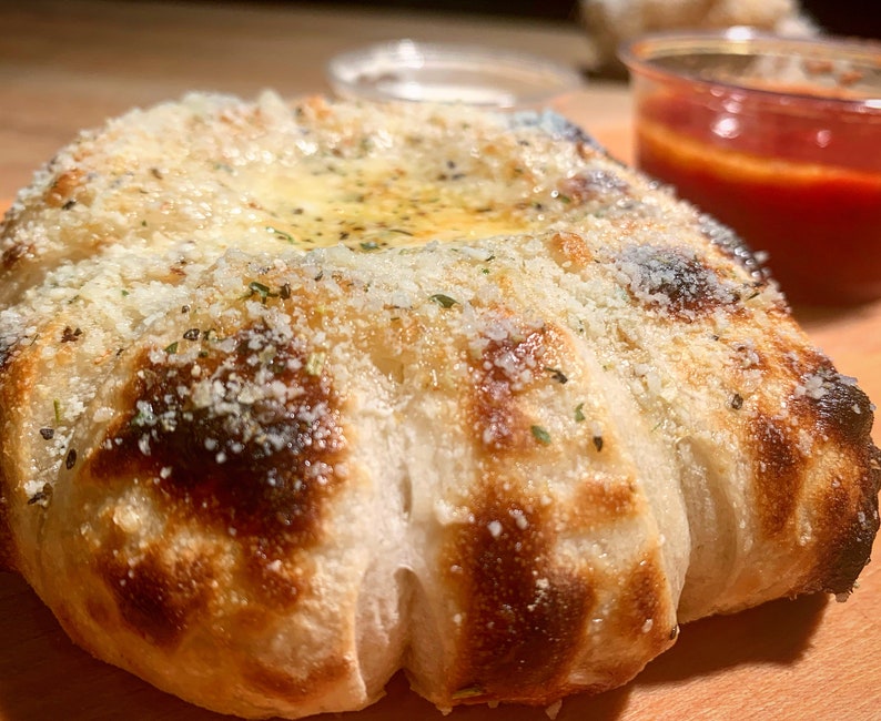 Puffy and chewy garlicky cheese pull apart monkey bread made from our starter