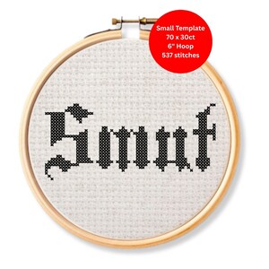 May include: A cross-stitch embroidery hoop with the word "Smut" stitched in black thread. The text is in a gothic font style. A red circle in the upper right corner indicates the template size, 6" hoop, and 537 stitches.