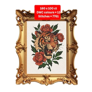 May include: Cross-stitch pattern of a tiger's head with red roses and green leaves, framed in a gold ornate frame. The text in the image reads: 160 x 100 ct, DMC colours = 13, Stitches = 7761.
