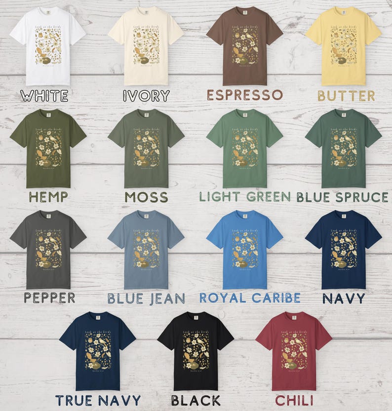May include: A collection of fifteen short-sleeve t-shirts in various colors including white, ivory, espresso, butter, hemp, moss, light green, blue spruce, pepper, blue jean, royal caribe, navy, true navy, black, and chili, each with a bird graphic.
