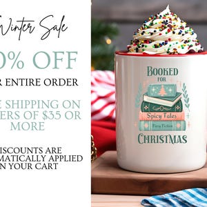 May include: White ceramic mug with a red handle. The mug has a design of a stack of books with the text "Booked for Christmas" and "Spicy Tales" on the front. The mug is filled with white whipped cream and colorful sprinkles.