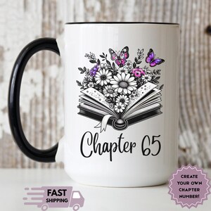 May include: White ceramic mug with a black handle and rim. The mug features a floral design with daisies, purple flowers, and butterflies above an open book. The text "Chapter 65" is written below the book.