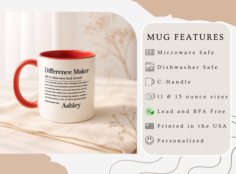 May include: White ceramic mug with a red interior and handle. The mug features the text "Difference Maker" with a definition and the name "Ashley". The mug is microwave and dishwasher safe, available in 11 and 15 ounce sizes, and printed in the USA.