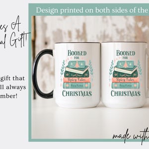 May include: White ceramic mug with a black handle. The mug has a design of a stack of books with the text "Booked for Christmas" on it. The design is printed on both sides of the mug.