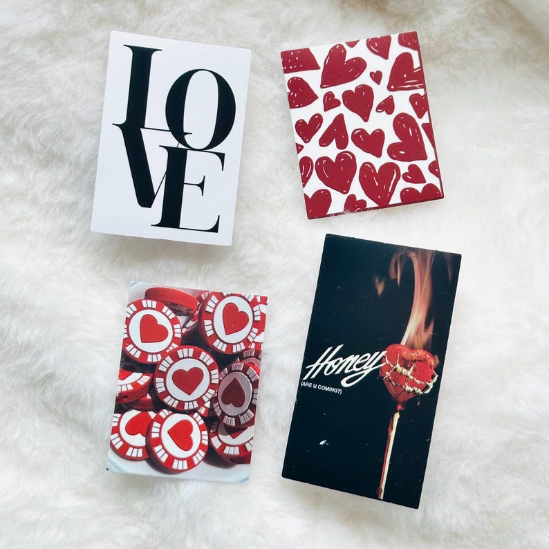May include: Four rectangular cards featuring distinct designs: one white card with the black text LOVE, one with a red heart pattern, one showing red and white heart-themed poker chips, and one black card with a burning heart and the text Honey ARE U COMING?