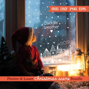 May include: A child in a Santa hat looks up at a window decorated with a winter scene. The window features white snowflake and house designs with the text "Cuddle weather." A lit lantern and candles add warmth to the cozy Christmas scene.