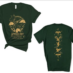 a green t - shirt with an image of a dragon on it
