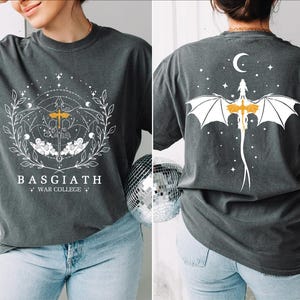 a woman wearing a t - shirt with a bat on it