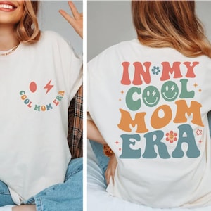 a woman wearing a t - shirt that says, in my cool mom era