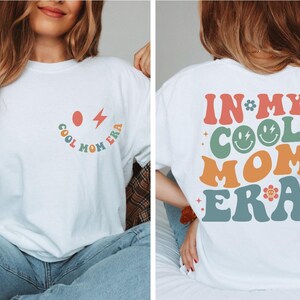 a woman wearing a white shirt that says in my cool mom era