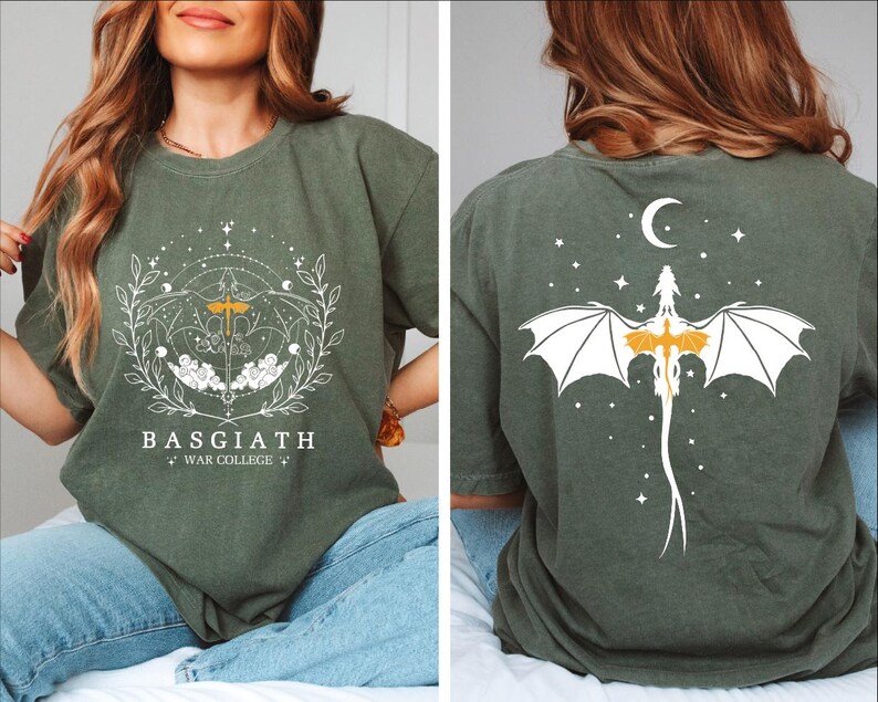 a woman sitting on a bed wearing a t - shirt with a bat on it