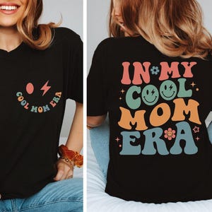 a woman wearing a black shirt that says in my cool mom era
