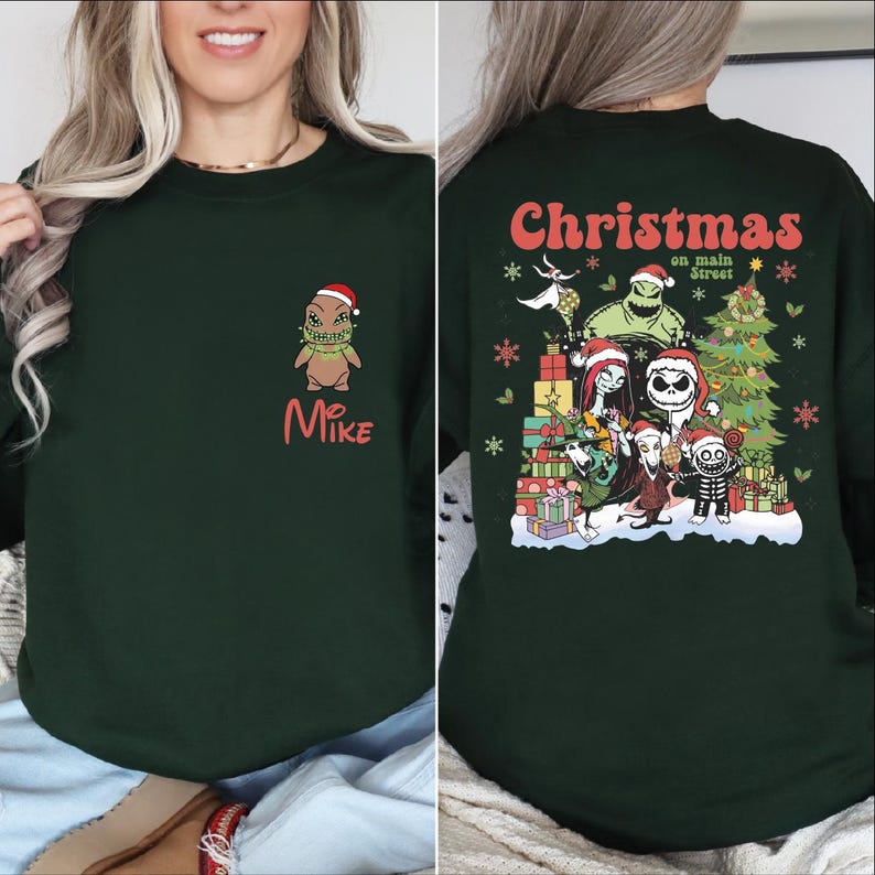 A woman wearing a green sweatshirt with a Christmas-themed design on the back.
