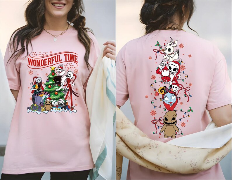 A woman wearing a pink t-shirt with a Christmas-themed design featuring characters from the movie " jack Skellington".