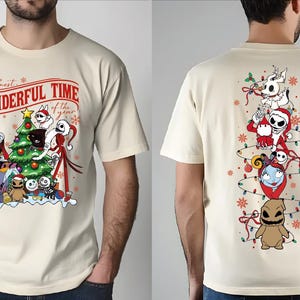 A white t-shirt with a graphic design featuring characters from the movie " Nightmare Before Christmas" and the text "The most wonderful time of the year".