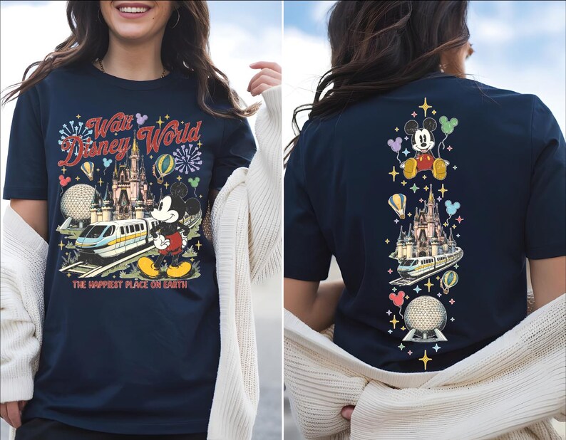 A woman wearing a navy blue t-shirt with a Disney World-themed design, including Mickey Mouse, the Eiffel Tower, and other iconic landmarks.