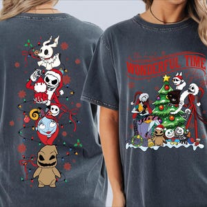 a gray t-shirt with a design of various characters from the movie "The Nightmare Before Christmas" and Christmas-themed elements.