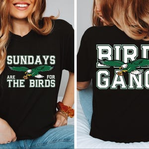 a woman wearing a black shirt with a bird gang on it
