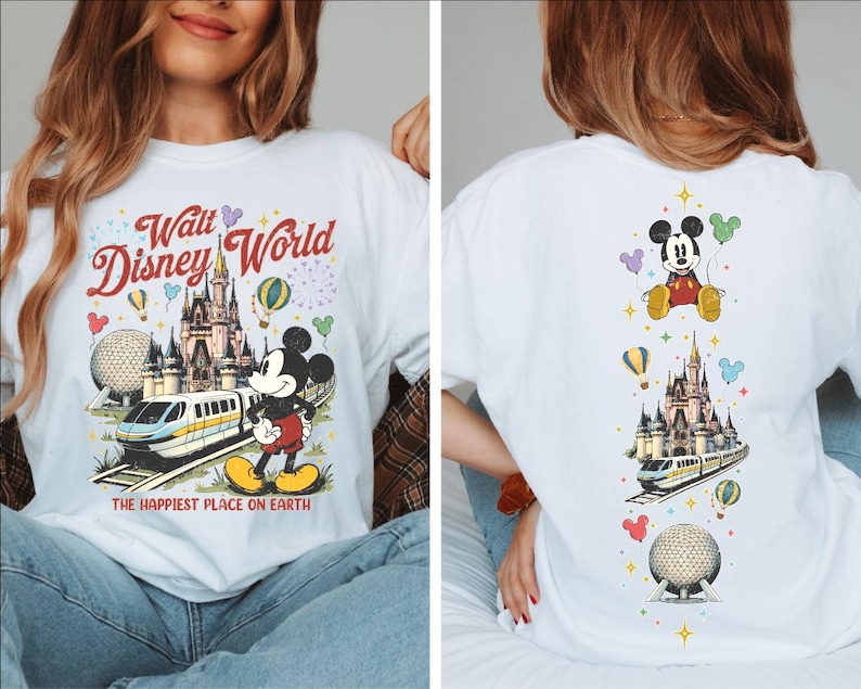 A woman wearing a white t-shirt with a Disney World-themed design, including Mickey Mouse, a castle, and various Disney-related elements.