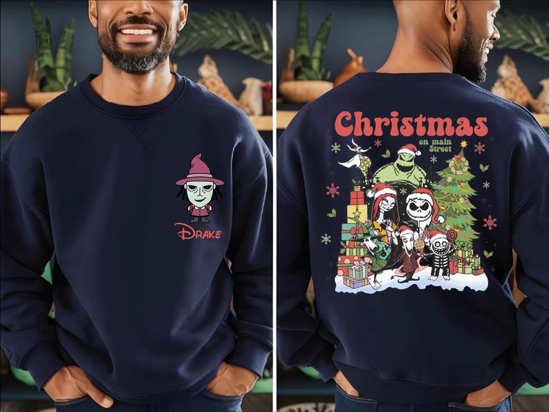 A man wearing a navy blue sweatshirt with a cartoon character on the front and a Christmas-themed design on the back.