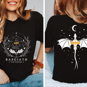 a woman wearing a black shirt with a white bat on it