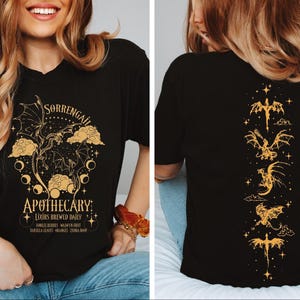 a woman wearing a t - shirt with an image of a dragon on it