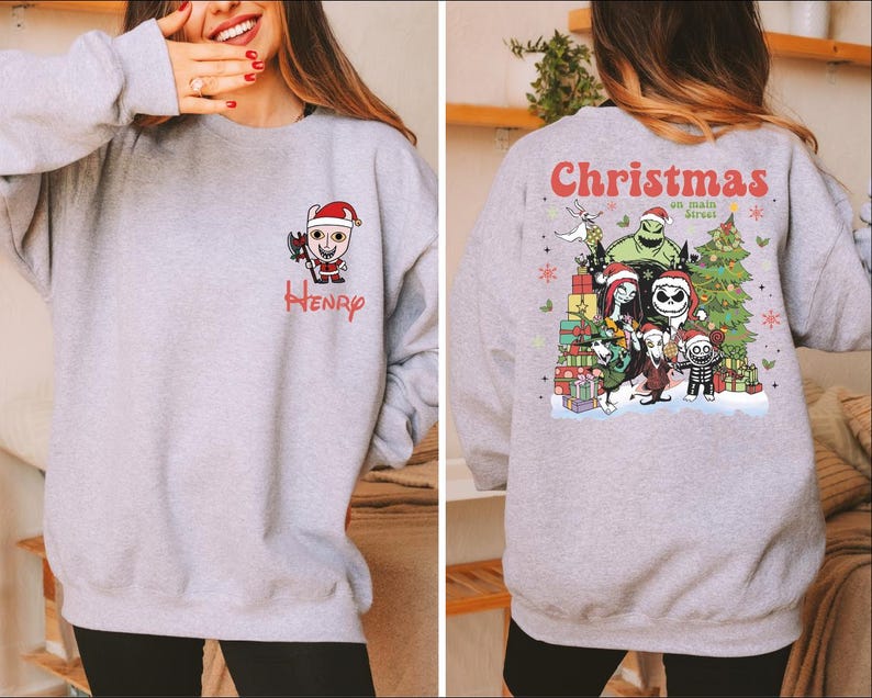 A woman wearing a gray sweatshirt with a Christmas-themed design on the back.