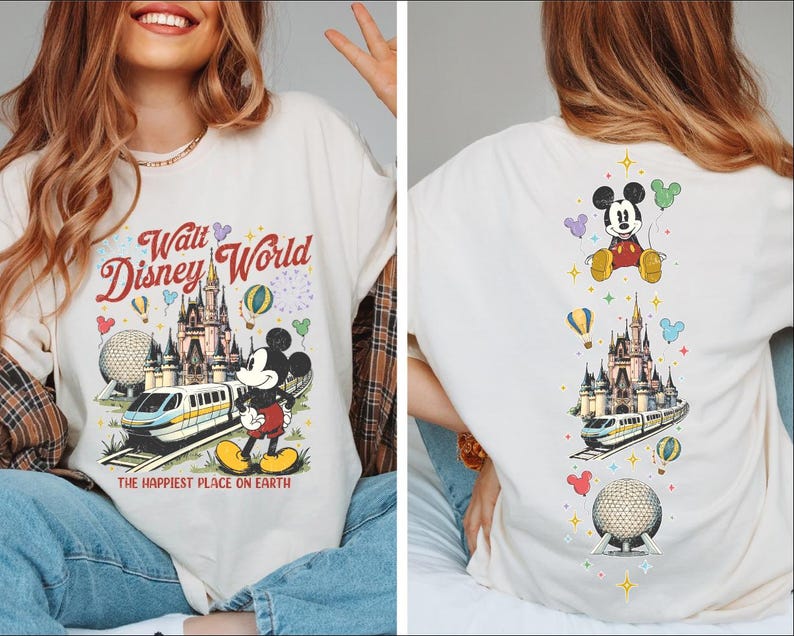 A woman wearing a white t-shirt with a Disney World-themed design, including Mickey Mouse, a castle, and various Disney-themed elements.